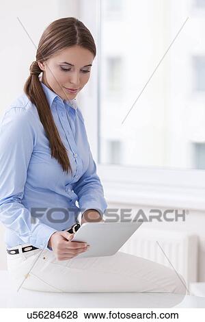 Stock Photo - Beautiful businesswoman using tablet computer . Fotosearch