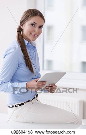 Beautiful businesswoman using tablet computer View Large Photo Image Stock Photo - Beautiful businesswoman using tablet computer . Fotosearch