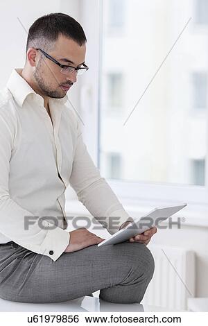 Businessman using tablet computer View Large Photo Image Stock Photograph - Businessman using tablet computer. Fotosearch