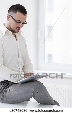 Businessman using tablet computer View Large Photo Image Stock Photograph - Businessman using tablet computer. Fotosearch