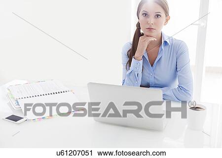 Businesswoman looking bored in front of laptop and television View Large Photo Image Stock Image - Businesswoman looking bored in front of laptop and television. Fotosearch