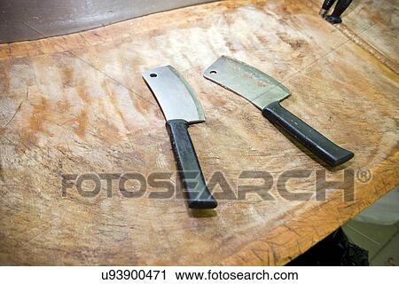 Butcher knife on cutting board in store View Large Photo Image Stock Image - Butcher knife on cutting board in store. Fotosearch