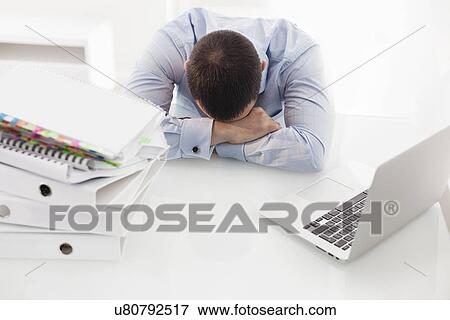 Caucasian businessman asleep at his desk View Large Photo Image Stock Photo - Caucasian businessman asleep at his desk. Fotosearch