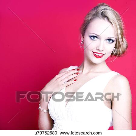 Stock Image - Caucasian woman wearing white dress on red background. Fotosearch