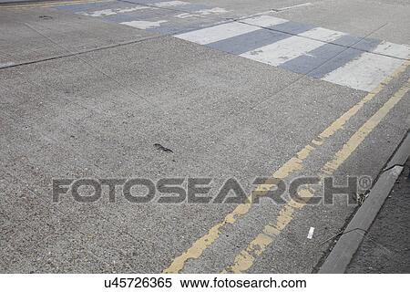 Stock Photography - Close-Up of double yellow line on road and Zebra crossing. Fotosearch