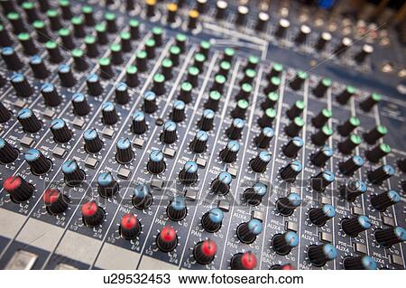 Stock Image - Close-up of sound mixing equipment in television station. Fotosearch