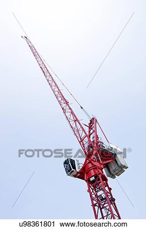 Close-up view of a red crane against sky View Large Photo Image Stock Image - Close-up view of a red crane against sky. Fotosearch