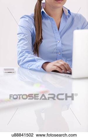 Close-up view of beautiful woman using laptop at desk View Large Photo Image Stock Image - Close-up view of beautiful woman using laptop at desk. Fotosearch