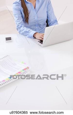 Close-up view of beautiful woman using laptop at desk View Large Photo Image Stock Photography - Close-up view of beautiful woman using laptop at desk. Fotosearch