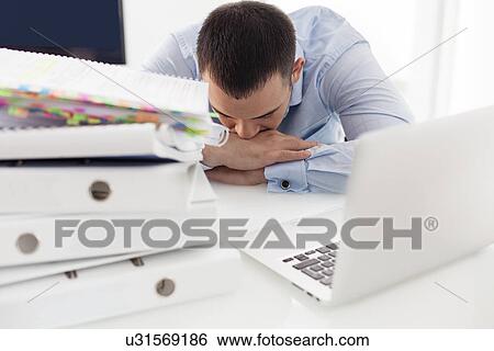Close-up view of Caucasian businessman asleep at his desk View Large Photo Image Stock Photograph - Close-up view of Caucasian businessman asleep at his desk. Fotosearch