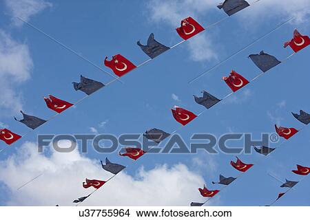 Picture - Close-up view of Turkish and EU bunting against clear sky. Fotosearch