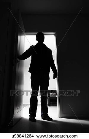 Picture - Full-length of thief entering into house. Fotosearch