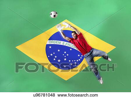 Goalkeeper saving ball in front of Brazilian flag View Large Photo Image Stock Photo - Goalkeeper saving ball in front of Brazilian flag. Fotosearch