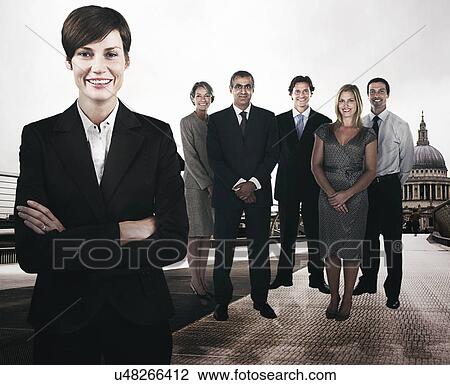 Stock Image - Group of businesspeople on the Millennium Bridge in front of St. Paul's Cathedral. Fotosearch