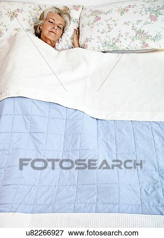 High angle view of senior woman sleeping in bed View Large Photo Image Stock Photo - High angle view of senior woman sleeping in bed. Fotosearch