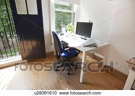 Stock Image - Interior of office with computer on desk. Fotosearch