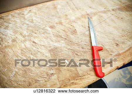 Kitchen knife on wooden cutting board in store View Large Photo Image Stock Image - Kitchen knife on wooden cutting board in store. Fotosearch