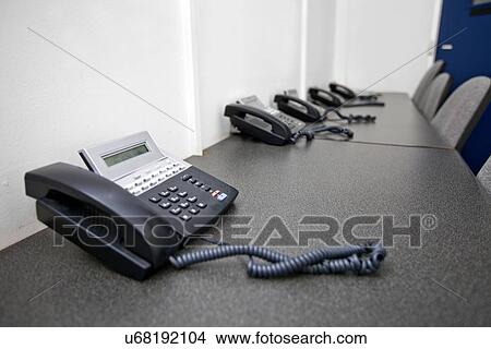 Picture - Landline telephones on table in television studio. Fotosearch