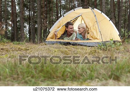 Loving young couple camping in forest View Large Photo Image Stock Image - Loving young couple camping in forest. Fotosearch