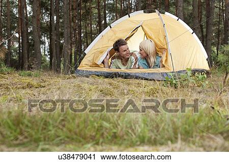 Loving young couple relaxing in tent View Large Photo Image Stock Image - Loving young couple relaxing in tent. Fotosearch