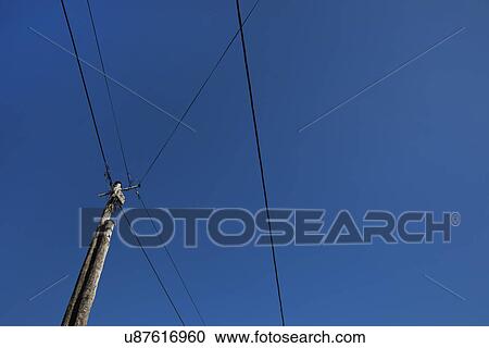 Low angle view of electric wires against clear blue sky View Large Photo Image Stock Image - Low angle view of electric wires against clear blue sky. Fotosearch