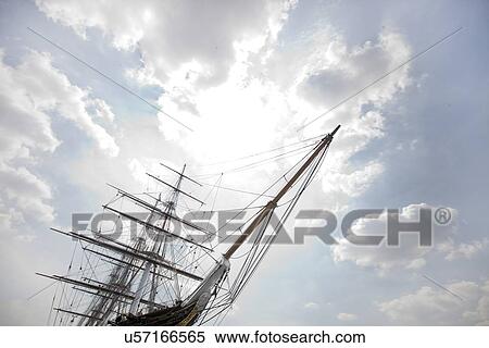 Low angle view of three masted ship against cloudy sky View Large Photo Image Stock Photography - Low angle view of three masted ship against cloudy sky. Fotosearch