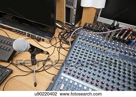 Stock Image - Microphone and sound mixing equipment at television studio. Fotosearch