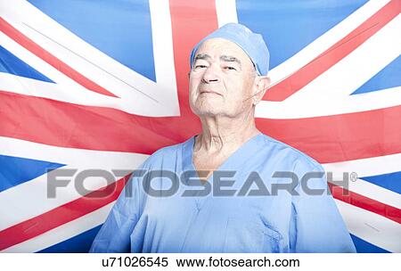 Stock Photography - Portrait of a Senior Adult Surgeon in front of a British Flag. Fotosearch