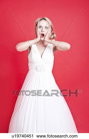 Stock Image - Portrait of shocked young Caucasian woman. Fotosearch