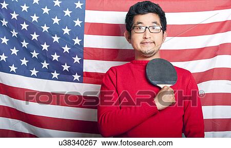 Proud Asian Man holding table tennis paddle against US Flag View Large Photo Image Stock Photo - Proud Asian Man holding table tennis paddle against US Flag. Fotosearch