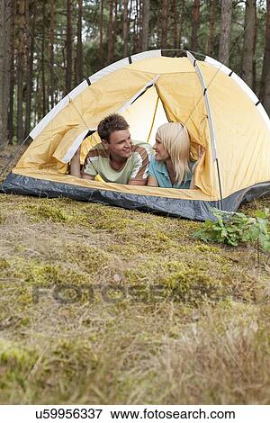 Stock Photo - Romantic young couple camping in forest. Fotosearch