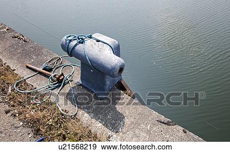 Stock Photo - Rusted Cleat on dock. Fotosearch