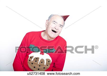 Senior adult man wearing a Christmas jumper and a red party hat View Large Photo Image Stock Photo - Senior adult man wearing a Christmas jumper and a red party hat. Fotosearch