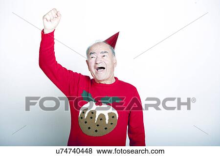 Senior adult man wearing Christmas jumper raising his arm in the air View Large Photo Image Stock Photo - Senior adult man wearing Christmas jumper raising his arm in the air. Fotosearch