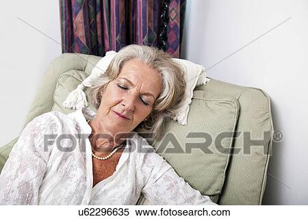 Senior woman sleeping on armchair at home View Large Photo Image Stock Photography - Senior woman sleeping on armchair at home. Fotosearch