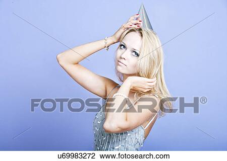 Sexy blonde party girl wearing silver dress and party hat View Large Photo Image Stock Image - Sexy blonde party girl wearing silver dress and party hat. Fotosearch