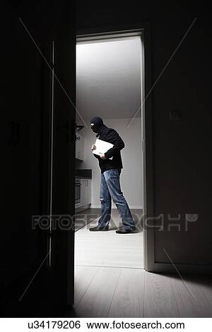 Side view of burglar stealing laptop from house View Large Photo Image Stock Photograph - Side view of burglar stealing laptop from house. Fotosearch