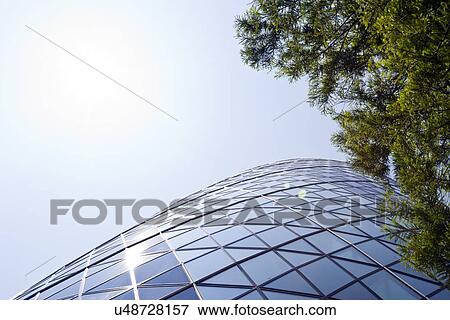Skyscraper seen though trees View Large Photo Image Stock Photo - Skyscraper seen though trees. Fotosearch