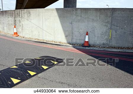 Speed bump in the middle of the road View Large Photo Image Picture - Speed bump in the middle of the road . Fotosearch