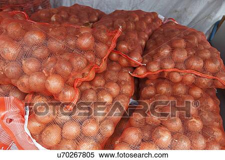 Stock Photography - Stack of onion sacks in grocery store. Fotosearch