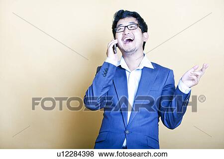 Stock Photo - Stylish Asian man on the telephone. Fotosearch