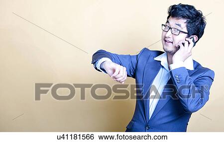 Stock Photograph - Stylish Asian man on the telephone. Fotosearch