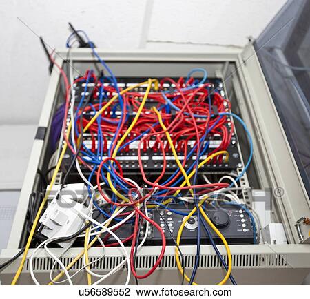 Stock Image - Tangled wires in server room at television station. Fotosearch