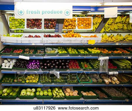 Various vegetables and fruits on display in grocery store View Large Photo Image Stock Photograph - Various vegetables and fruits on display in grocery store. Fotosearch