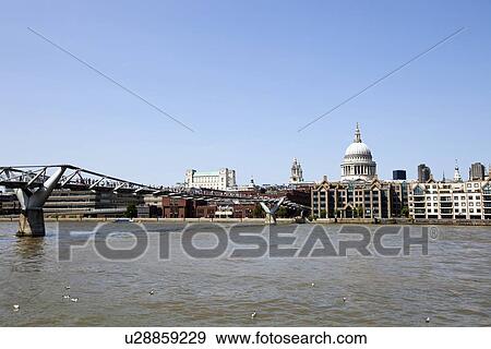 View of Millennium Bridge with view of City of London in the Background View Large Photo Image Stock Photo - View of Millennium Bridge with view of City of London in the Background. Fotosearch
