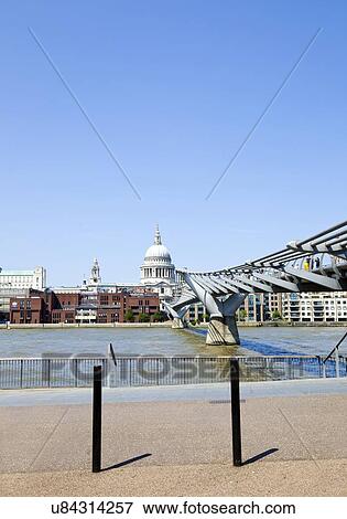 Stock Photo - View of Millennium Bridge with view of City of London in the Background. Fotosearch