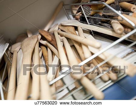 Stock Image - Wooden spatulas on shelf in utensil store. Fotosearch