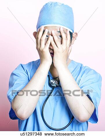Young Asian surgeon wearing scrubs and looking stressed View Large Photo Image Stock Photo - Young Asian surgeon wearing scrubs and looking stressed. Fotosearch
