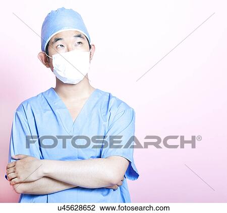 Young Asian surgeon with arms folded View Large Photo Image Stock Image - Young Asian surgeon with arms folded. Fotosearch