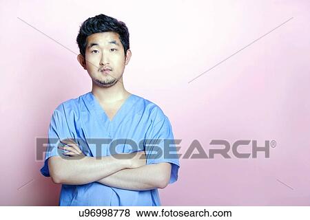 Young Asian Trainee Doctor wearing Scrubs View Large Photo Image Stock Photo - Young Asian Trainee Doctor wearing Scrubs. Fotosearch